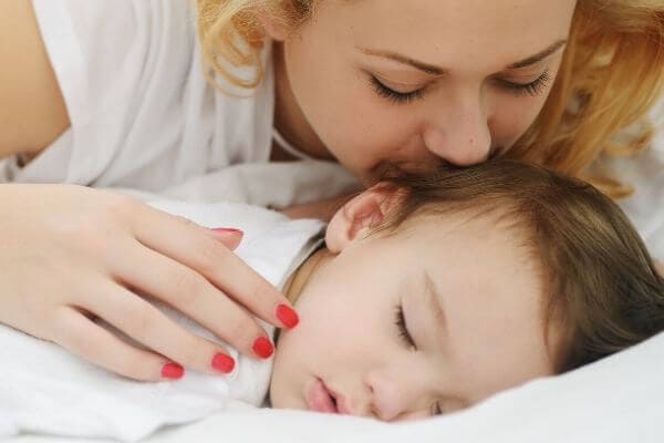 Mom Kissing Sleeping Child | To My Child: I will lay with you all night as long as you need.