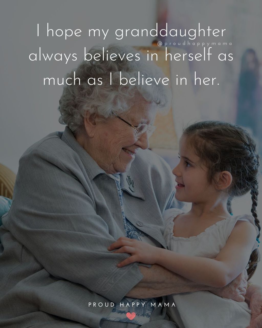 Grandmother looking loving at granddaughter while her granddaughter is sitting in her lap. With text overlay, ‘I hope my granddaughter always believes in herself as much as I believe in her.’