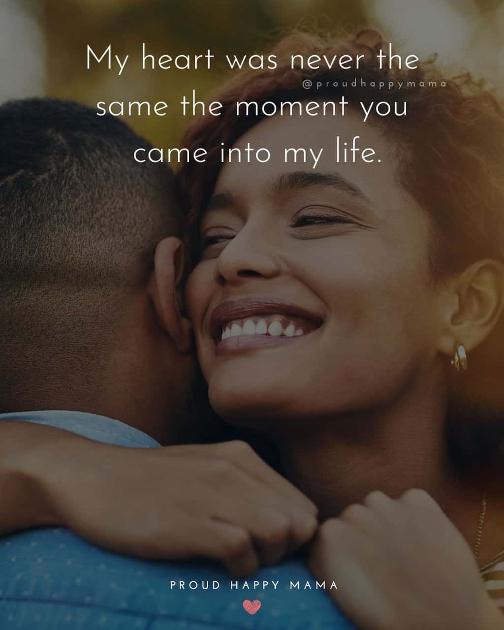 Smiling women hugging boyfriend with love words for her text overlay. ‘My heart was never the same the moment you came into my life.’