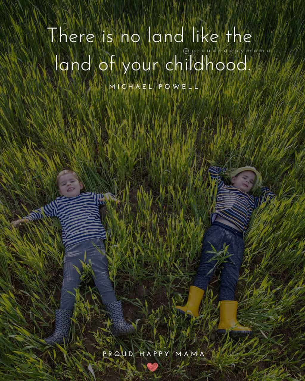 Two young boys laying in tall grass with un childhood quote text overlay. ‘There is no land like the land of your childhood.’ – Michael Powell