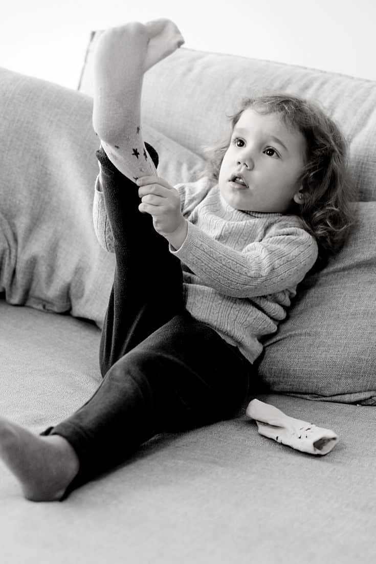 child learning to put on sock